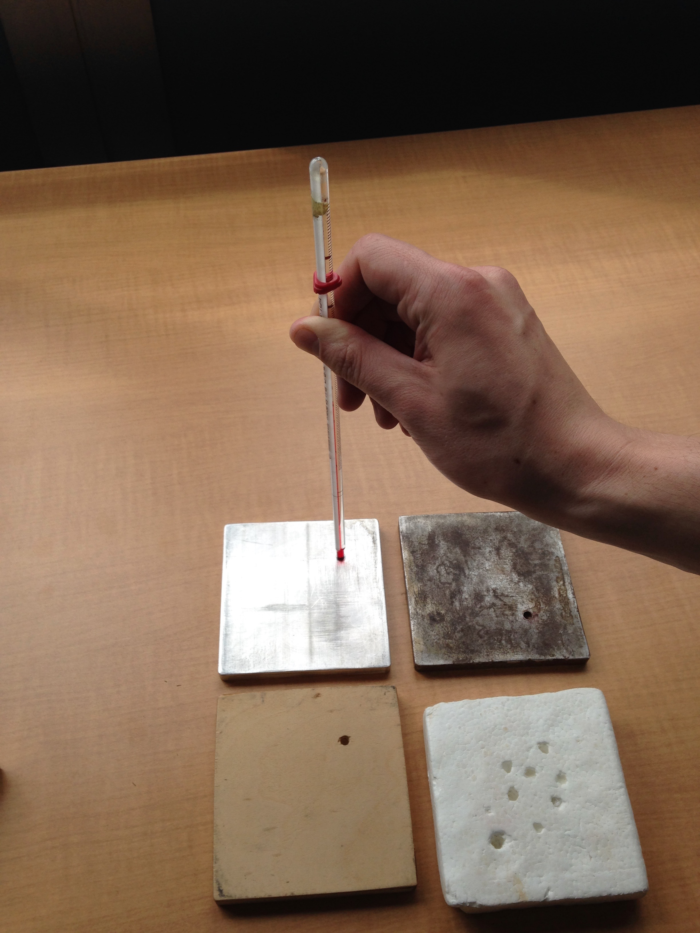 Styrofoam, wood, and two kinds of metal blocks and a thermometer.