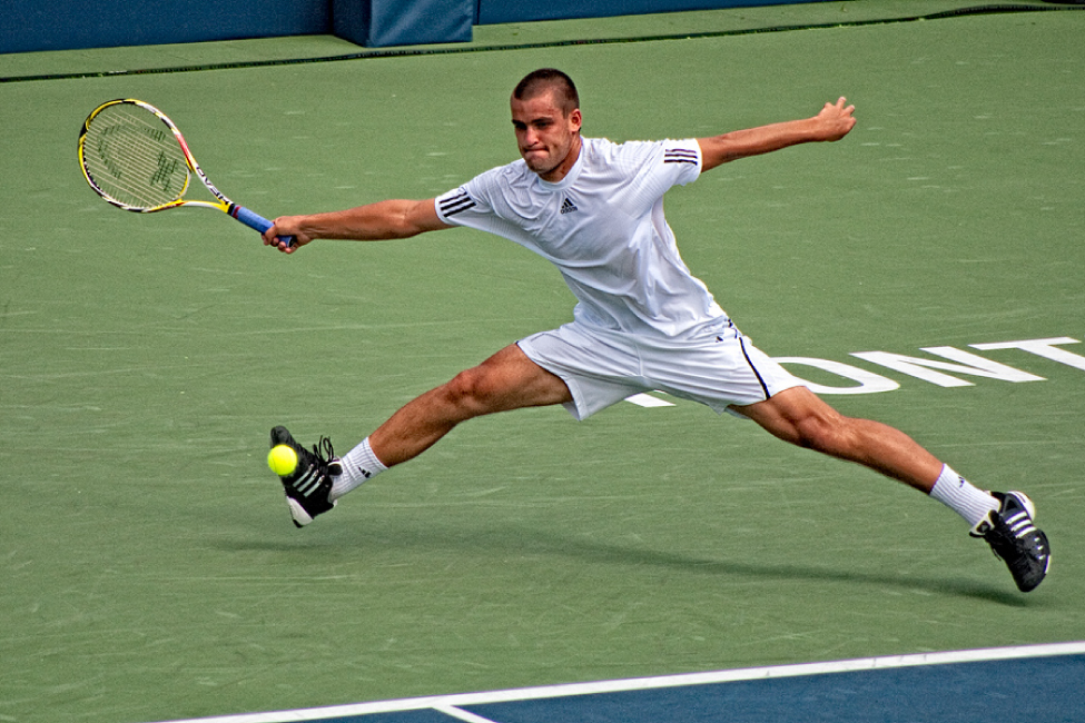 This photograph shows a man playing tennis.