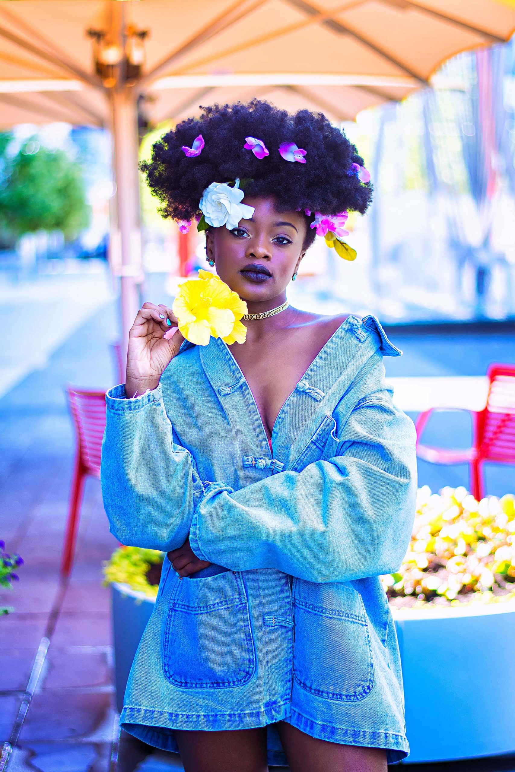woman wearing blue denim jacket with flowers in hair (link to file)