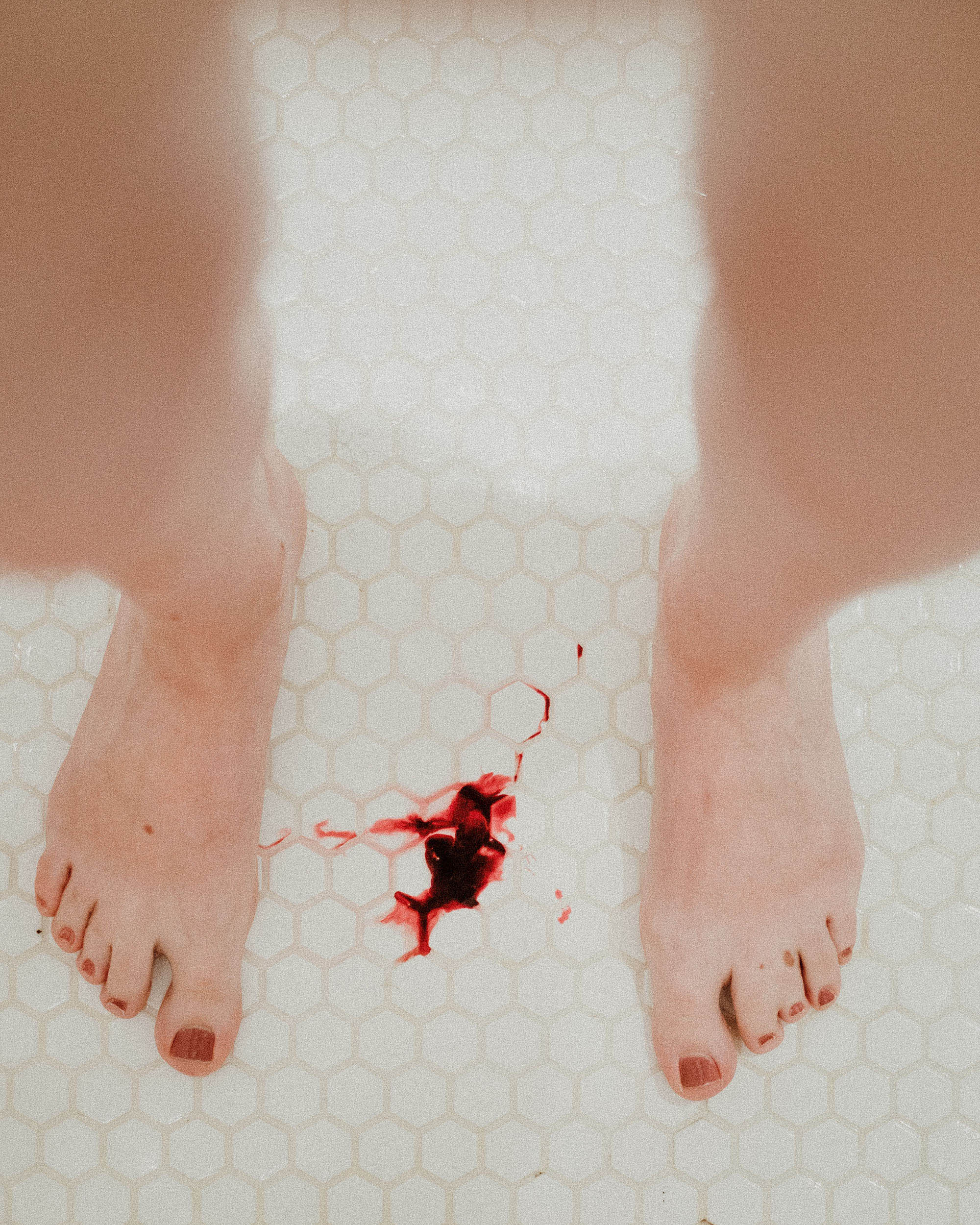 pair of legs with blood on floor (link to file)