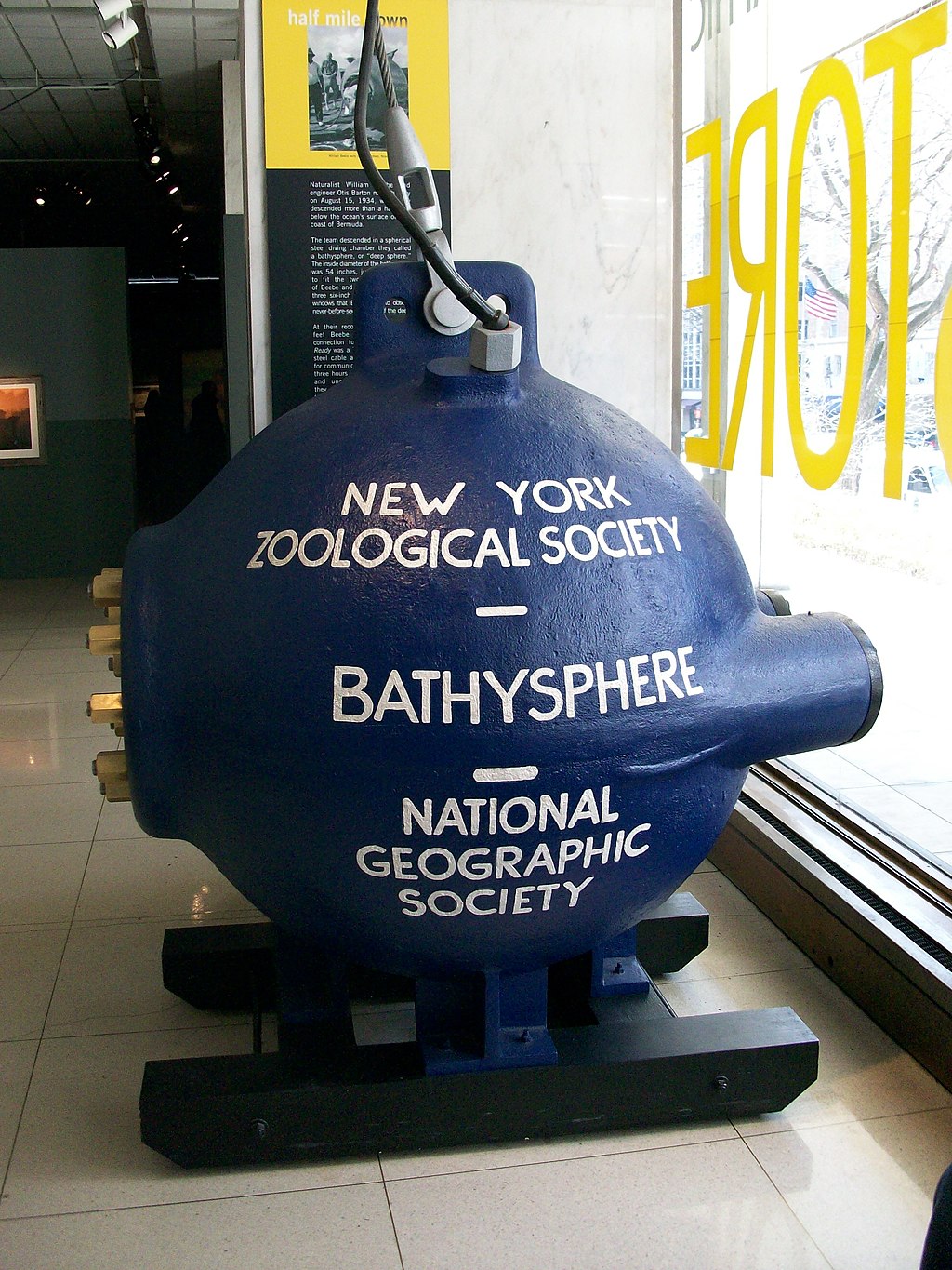 Dark-blue bathysphere imprinted 'New York Zoological Society,' 'Bathysphere,' and 'National Geographic Society' in white text